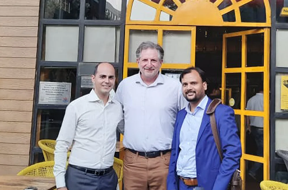 Three Bluemeteor colleagues standing together and smiling